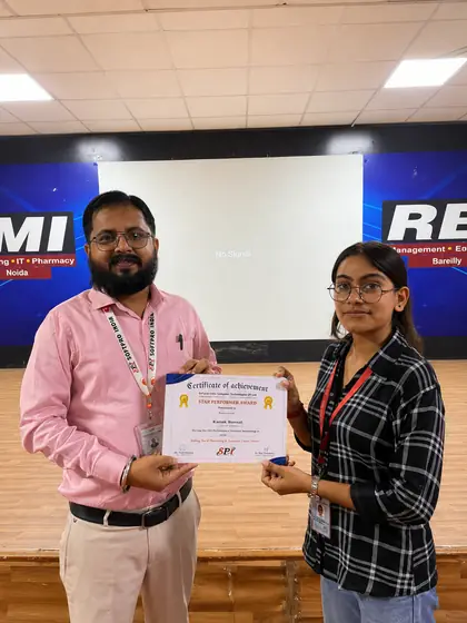 A SSS trainer handing a star performer certificate to a student in front of the event backdrop